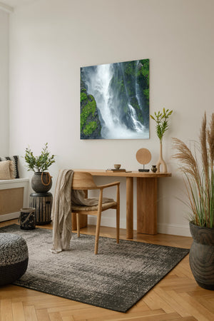 Moss-covered fjord rock wall with cascading water