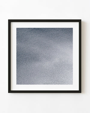 Fine sea spray creates a soft grey abstract texture of countless water droplets.