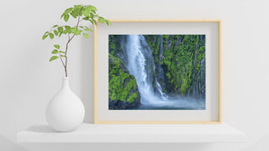 Water cascades across rugged cliffs in Fiordland National Park.