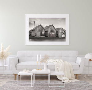 Maritime architecture of PEI fishing huts under cloudy skies