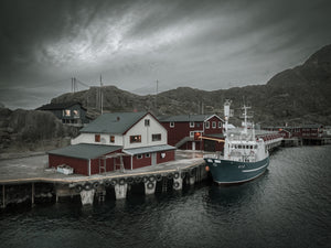 Aerial view of red fishing buildings and boat in Mortsund