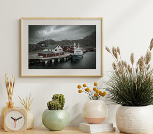 Moody coastal harbor scene with boat and dark water
