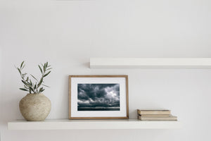 Moody Florida coastal photograph showing heavy cloud textures above rippled water.