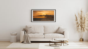 Florida Keys sunset photograph showing a glowing sky above the Seven Mile Bridge and distant shore.