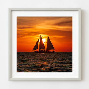 Charter sailboat silhouette at sunset off Florida coast