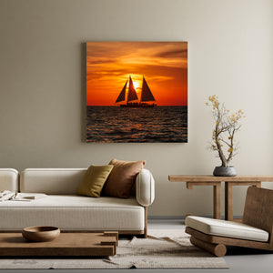 Silhouette of sailing charter against red sunset sky