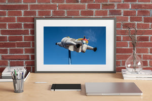 Tin horse flying against blue sky