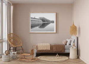 Black and white architectural photograph of the Forbidden City wall beside calm water.