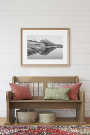 A peaceful Beijing moat scene with historic stonework, bare trees and mirrored water.