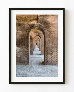 Tall brick arches repeat into the distance inside historic Fort Jefferson in the Florida Keys.