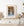 Successive rounded arches frame a narrow passage and pale worn floor.