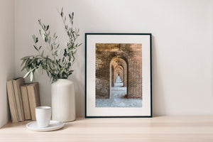 Light and shadow reveal the textured brickwork of Fort Jefferson’s arched passage.