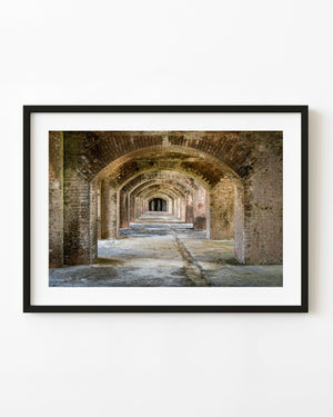 Repeating weathered brick arches recede through the historic gunrooms of Fort Jefferson.
