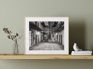 Worn stone floors and a metal staircase inside the historic Fremantle Prison cell block