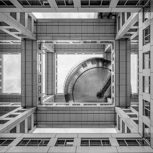 Square architectural photograph of repeated rectangular structures surrounding Fuji TV’s sphere