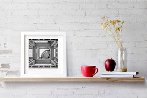 Black and white geometric architecture with grid-patterned walls and an inset metal sphere