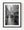 A man looks back between stopped freight trucks on a Ganzi highway in black and white