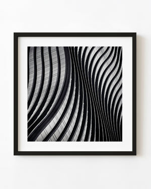 Flowing curves and reflective glass form an abstract black and white pattern on Garak Tower’s façade