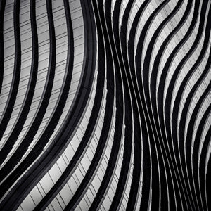 Square monochrome architectural detail of curved bands on Garak Tower East in Seoul