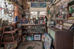 Colour interior photograph of a Route 66 room crowded with photographs and Sinclair collectibles