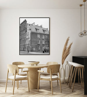 Repeated windows and textured brickwork define neighbouring buildings on a Gdańsk street