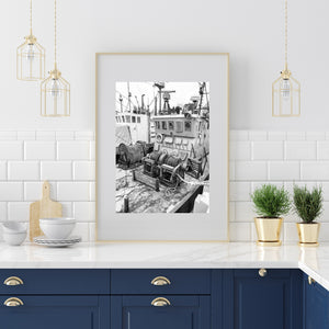 Old fishing vessels sit close together with masts, lamps and weathered deck gear