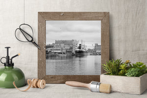 Black and white Gdańsk harbor scene with a docked ship beneath an overcast sky