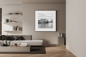 Ripples fill the foreground below a ship and tiled rooftops on the Gdańsk waterfront