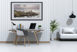 Penguins with icebergs and stormy sky in background