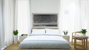 Angular sunshades form a rhythmic pattern across a monochrome architectural detail