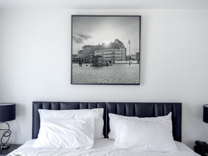 A square monochrome city view with patterned paving and historic German architecture