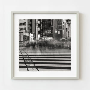 Framed black and white photograph of a city street with a crosswalk.