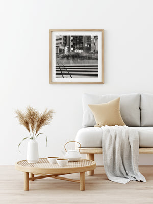 Modern living room with a sofa, coffee table, and framed artwork on the wall.