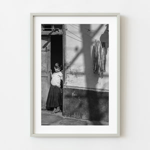 Young girl in doorway of her home in Mysore, India