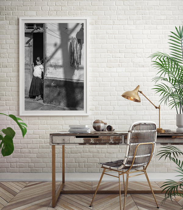 Quiet moment of young girl standing in the doorway