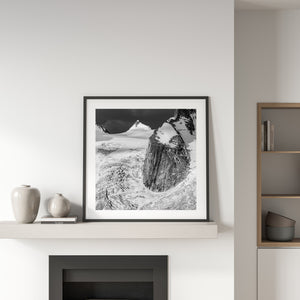 Snow-covered peaks and broken glacier ice form a stark monochrome alpine landscape