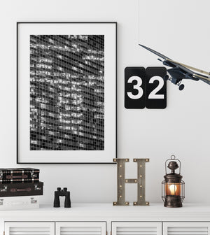 A dense window grid creates an abstract pattern of light and shadow at night