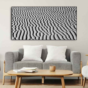 Curved desert sand lines form a natural black and white abstract pattern