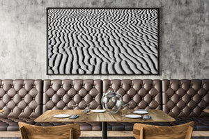 A wide monochrome photograph captures repeating waves of Gobi Desert sand