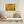 Dark twisting branches weave through layers of vivid yellow autumn leaves