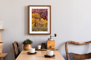A vertical landscape photograph captures autumn cottonwoods beneath Zion cliffs