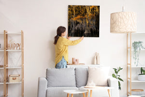 Moss-draped cypress trees form a richly textured golden waterside scene