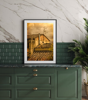 Old roof tiles and rustic village walls form a richly textured Tuscan scene