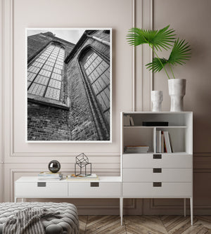 A black and white architecture photograph looks upward along Gothic church walls