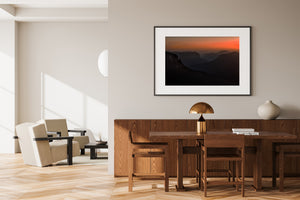 A horizontal landscape photograph shows hazy Blue Mountains cliffs at first light