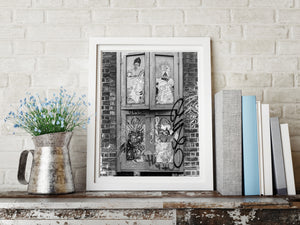 A vertical monochrome photograph shows layered graffiti and portraits on closed shutters