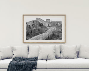 A Great Wall stairway crosses rugged winter slopes beneath a pale sky