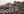 Weathered brick towers and battlements rise across a rocky Chinese hillside