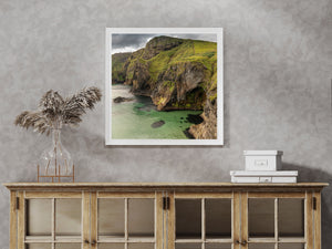 A shadowed cave opens beneath weathered cliffs along Ballintoy’s shoreline