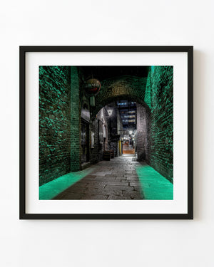 Green light illuminates brick walls around Merchant’s Arch in Dublin at night